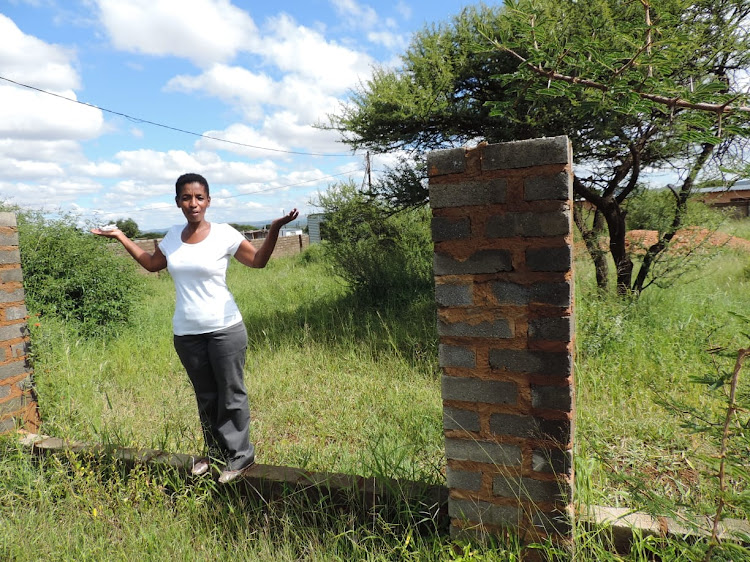 The mother of Progeria sufferer Ontlametse Phalatse‚ who died at the age of 18, three years ago, on the plot where she is awaiting the new-built house that was promised to her.