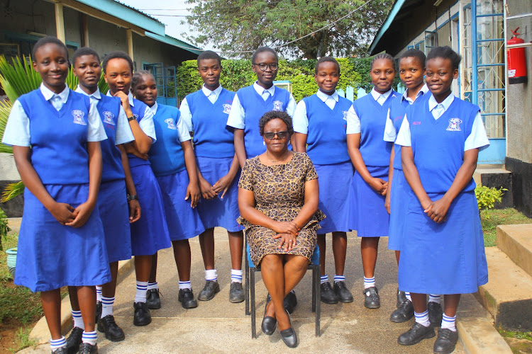 Chief Principal Esther Amukwach pose in a photo with student leaders at the school premises.