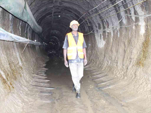 A construction worker inside the Northern Water Collector Tunnel in Makomboki, Murang’a county