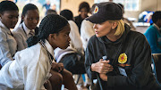 South African-born actress Charlize Theron has a one on one with one of the school pupils of Dlanathi in Pietermaritzburg, during a visit which is one of nine charity project she runs in South Africa where she engaged with local children about social issues

