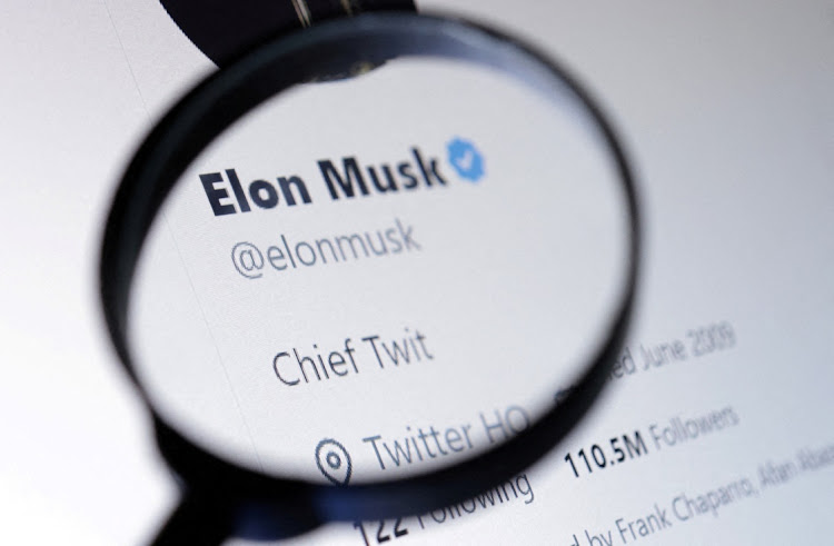 Elon Musk's Twitter account is seen through a magnifier in this illustration taken on October 28 2022. Picture: REUTERS/DADO RUVIC