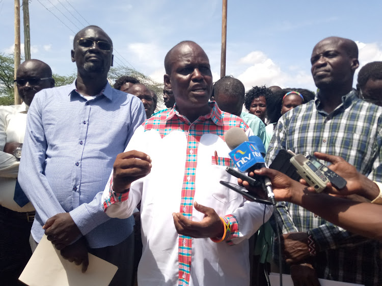 Turkana Governor Jophat Nanok (left) MPs Jeremiah Lomurkai (C) and Christopher Nakuleu addresses press at Lodwar County Headquarters