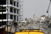 A rescue member works on the debris as search and rescue efforts continue at the site of a collapsed building in Ikoyi, Lagos, Nigeria November 2, 2021.  