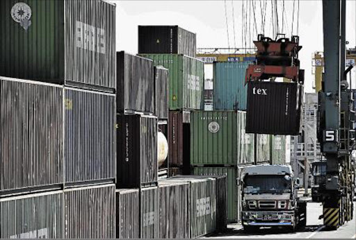 A crane loads a container on to a truck at Aomi container terminal in Tokyo,Japan.