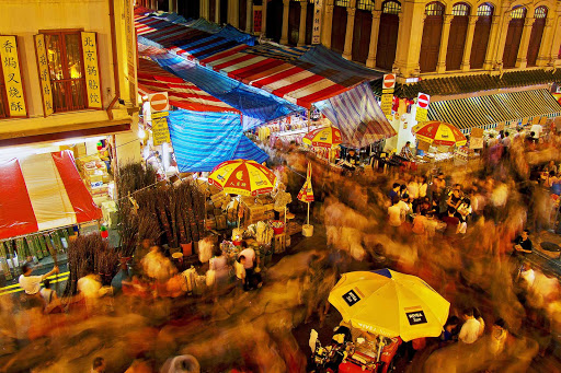 The bustle of Chinatown in the evening in Singapore.