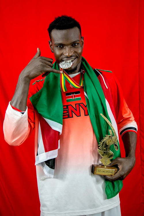 Kenya's Tom Wamukota with his trophy