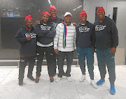 Champion Zolani Tete, second from right, and his team were met at their hotel by SA ambassador  Ahlangene Sigcawu (white top).