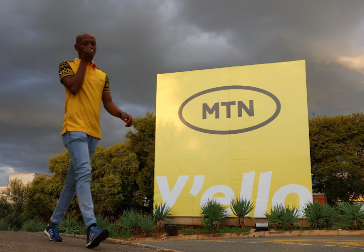 A man walks past an MTN logo outside the company's headquarters in Johannesburg, South Africa, March 13, 2023. Picture: REUTERS/Siphiwe Sibeko