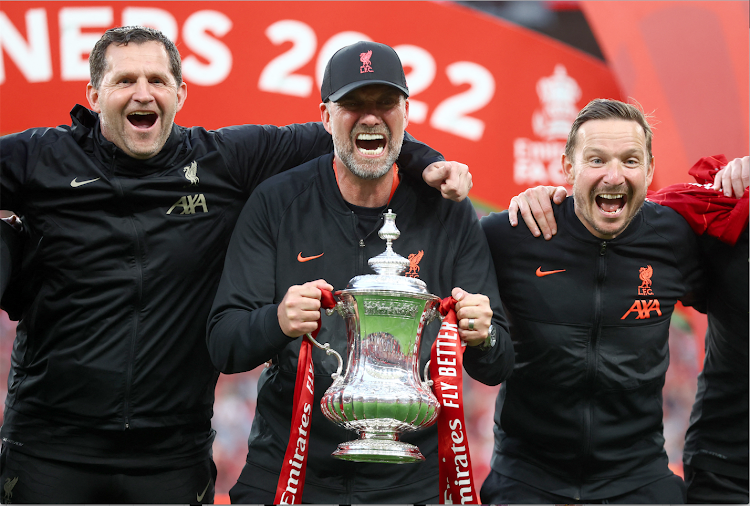 Liverpool manager Jurgen Klopp and his coaching team celebrate with the trophy after winning the FA Cup final