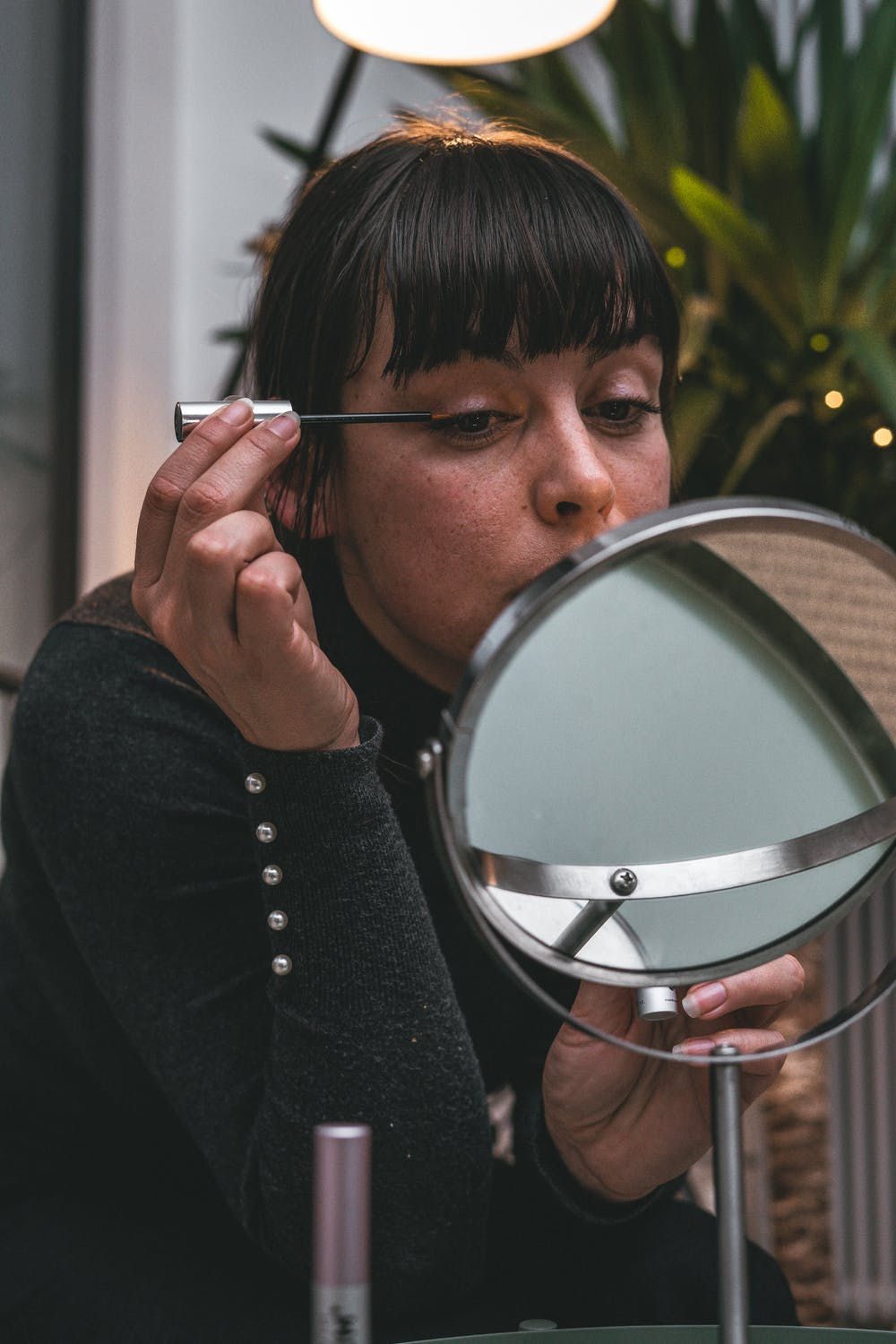 image depicting someone drawing on eyeliner