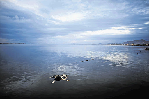 NATURE'S WRATH: The bodies of a woman and child, victims of super typhoon Haiyan, float in the sea off Tacloban yesterday. The death toll from one of the world's most powerful typhoons surged this weekend, but the aid effort was still a struggle as bodies lay uncollected Picture: REUTERS