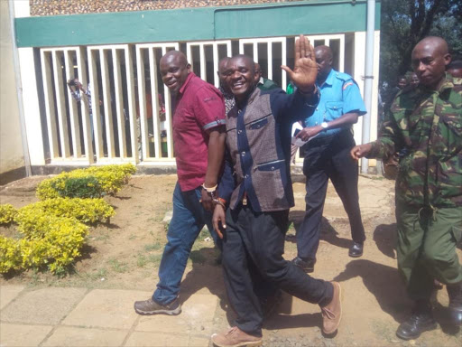 Kenneth Barasa and Nahashon Omondi are led away from Kitale High court in the case of former Saboti CDF manager Joshua Orina's murder, July 18, 2018. /CORAZON WAFULA