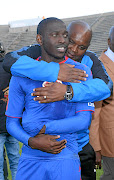 Mamelodi Sundowns coach  Pitso Mosimane embraces SuperSport United player Aubrey Modiba. 