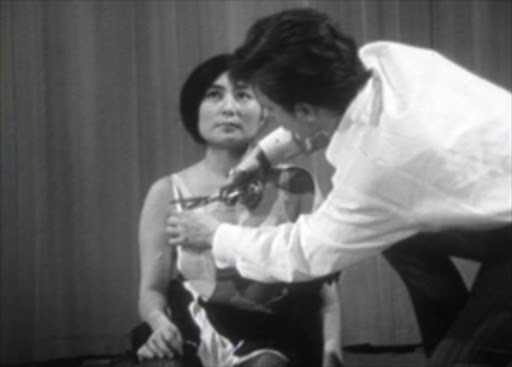 Cut Piece, audience is invited to cut off a piece of clothing, Yoko Ono, 1965. Photo: performane' still, Albert and David Maysles film.