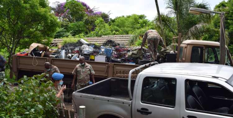 Goods from the house were loaded onto a military truck.