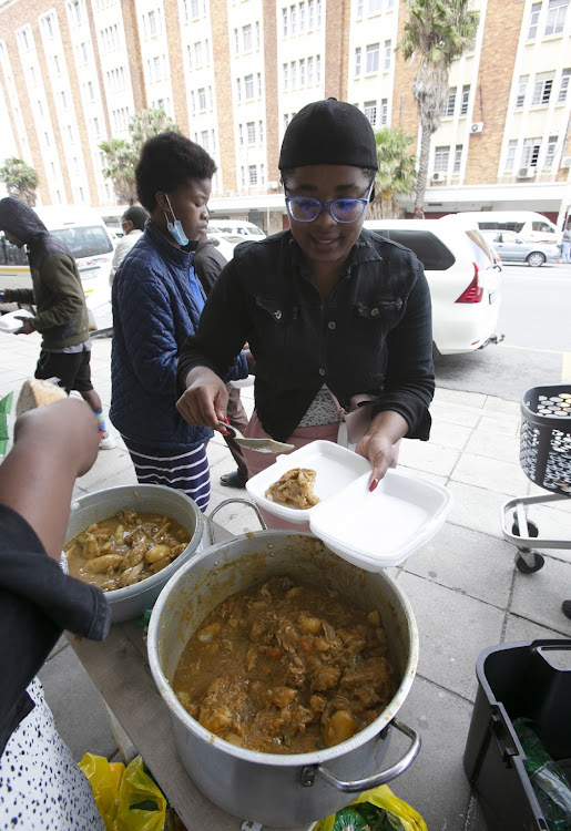 From her own pocket Nangamso Simayile a Fort Hare student who coocked and served chicken stew for the Needy in the East London CBD.