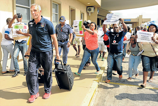 UNDER THE COSH: Chippa United coach Ernst Middendorp receives a hot welcome at PE Airport by disgruntled fans yesterday Picture: MIKE HOLMES