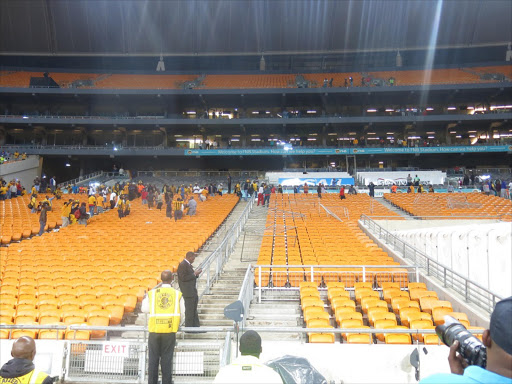 Angry Kaizer Chiefs supporters destroy security fans at FNB Stadium on Tuesday evening after a 1-0 defeat by Jomo Cosmos. Picture credits: Sowetan LIVE