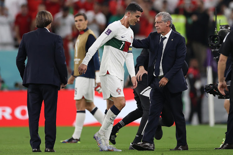 Portugal head coach Fernando Santos pats Crstiano Ronaldo on the back after the team's defeat during the FIFA World Cup Qatar 2022 quarterfinal against Morocco at Al Thumama Stadium on December 10, 2022 in Doha