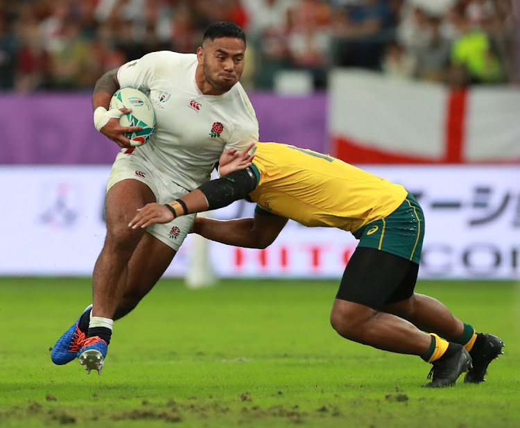 Manu Tuilagi of England is tackled by Samu Kerevi during the Rugby World Cup quarterfinal against Australia at the Oita Stadium in Japan in October 2019. Tuilagi has joined Sale Sharks until the end of next season.