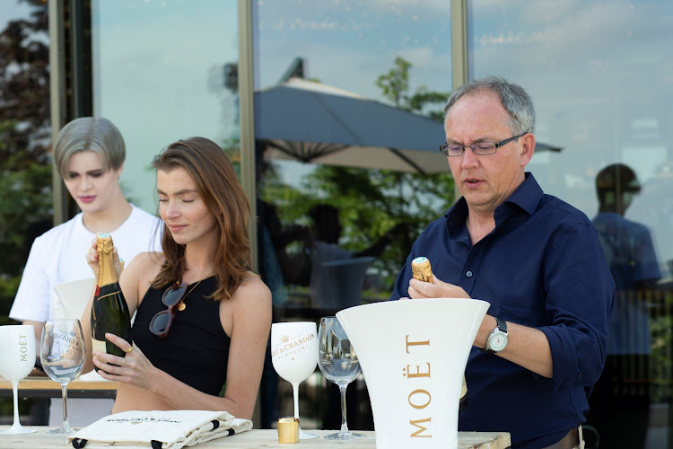 Mark Smyth learning how to open the champagne bottle correctly.