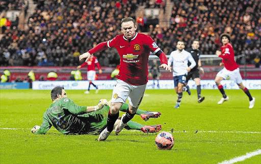 IS IT A DIVE? Wayne Rooney of Manchester United appears to draw a foul from goalkeeper Thorsten Stuckmann of Preston North End to win a controversial penalty during the FA Cup fifth-round match at Deepdale