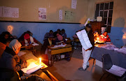 An election official counts votes after the close of Lesotho's parliamentary election at Loretto Catholic mission school outside the capital Maseru, Lesotho, October 7, 2022. 