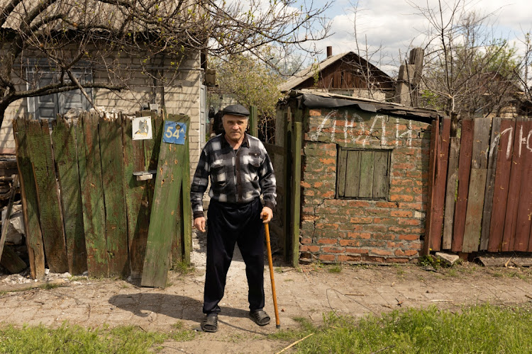 A resident who refused to evacuate, poses in front of his house in the front-line city of Lyman, Donetsk region, Ukraine, April 25 2022