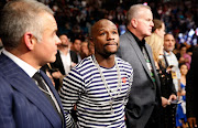 Former boxing champion Floyd Mayweather Jr. (C) waits for the start of the WBA featherweight title fight between Carl Frampton and Leo Santa Cruz at MGM Grand Garden Arena on January 28, 2017 in Las Vegas, Nevada.