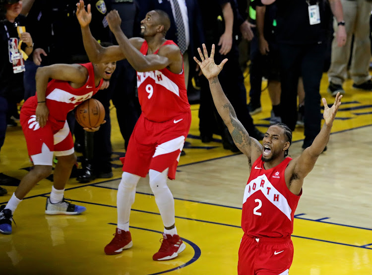 Toronto Raptors forward Kawhi Leonard (2) and Toronto Raptors guard Kyle Lowry (7) celebrate winning the NBA Championship over the Golden State Warriors against game six of the 2019 NBA Finals at Oracle Arena.