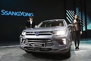 A model poses next to a SsangYong Korando at the Seoul Motor Show 2019 at KINTEX on March 28 2019 in Goyang, South Korea.