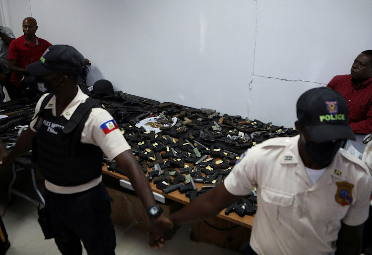 Weapons confiscated in police operations against increasingly powerful gangs are presented to the media, after at least 75 people have been killed in turf wars that broke out two weeks ago between gangs, according to the United Nations Integrated Office in Haiti, in Port-au-Prince, Haiti May 9 2022. Picture: REUTERS/RALPH TEDY EROL