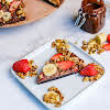 Thumbnail For Chocolate Drizzled Over A Slice Of Banana Split Brownie Pizza.