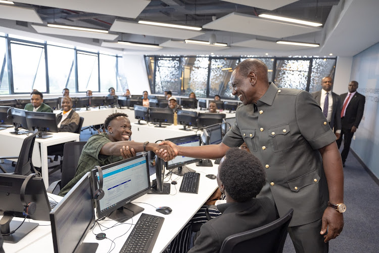 President William Ruto shakes hand with one of the staff at the Call Centre International(CCI) Global Contact Centre, Tatu City, Kiambu County during its launch on May 10, 2024.