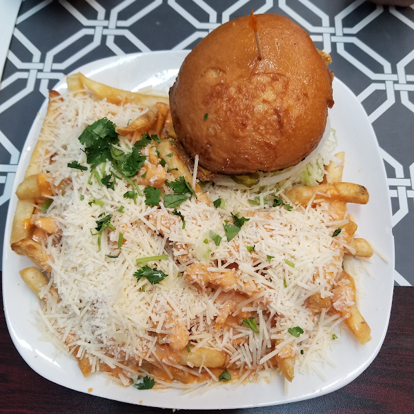 Fried fish sandwich with dirty fries, absolutely gluten free. The fish filet is hand breaded by the owner. The most crispy, flavorful scratch made fish fillet you'll ever eat!