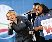 Helen Zille, premier of the Western Cape, and Lindiwe Mazibuko, parliamentary leader of the Democratic Alliance, sing with local artist Lauren Erasmus at the DA's launch of its registration campaign in Mitchells Plain, Cape Town. File photo.