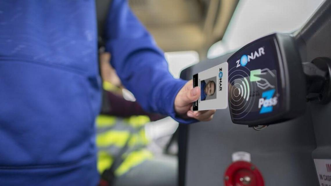 photo of a student swiping their z pass to get on a school bus