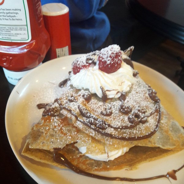 Nutella with fresh cream and strawberries crepe