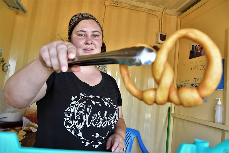 Sylvia Bichanga displays a sample of her food called pretzels.