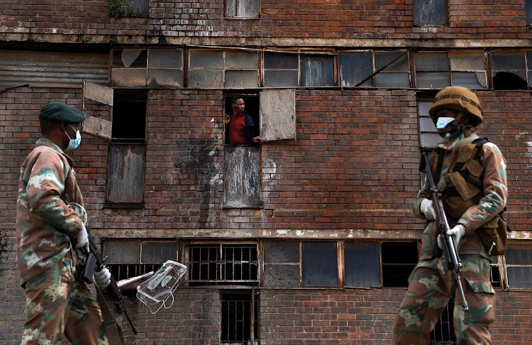 STAY INSIDE: Police and members of the SANDF patrol streets and hostels in Alexandra, Johannesburg, on Saturday as part of regulations to halt the spread of the Covid-19 virus