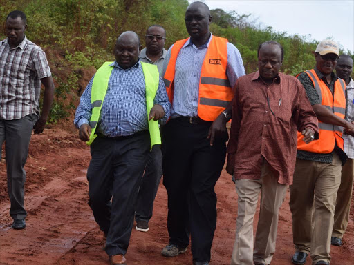 Principal Secretary for Infrastructure Engineer John Mosonik accompanied by Engineer Jared Makori and Kiango MP Gonzi Rai when he toured Marere -Kinango bridhe to assess the damage/ALLOYS MUSYOKA