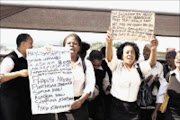 UP IN ARMS: GM Pharmaceuticals employees protested over a number of grievances, including low salaries and poor working conditions outside Ishmael Mohammed's pharmacy in Pinetown. 30/03/200. Pic. Thuli Dlamini. © Sowetan.