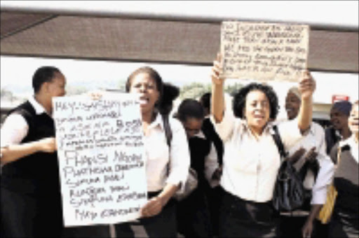 UP IN ARMS: GM Pharmaceuticals employees protested over a number of grievances, including low salaries and poor working conditions outside Ishmael Mohammed's pharmacy in Pinetown. 30/03/200. Pic. Thuli Dlamini. © Sowetan.