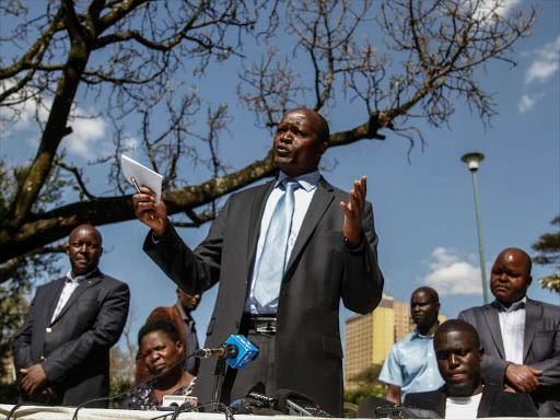 Migori Governor Okoth Obado with his family and some county staff during a press conference on the matter of Rongo University student Sharon Otieno's murder, Nairobi, September 12, 2018. /ENOS TECHE