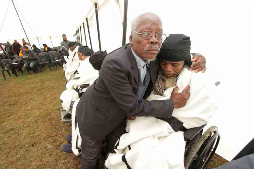 DAD’S PRIDE: Tears of joy flow as parents celebrate the initiation graduation of their disabled sons at Nomzamo Centre for the Disabled in Peddie yesterday Picture: LULAMILE FENI