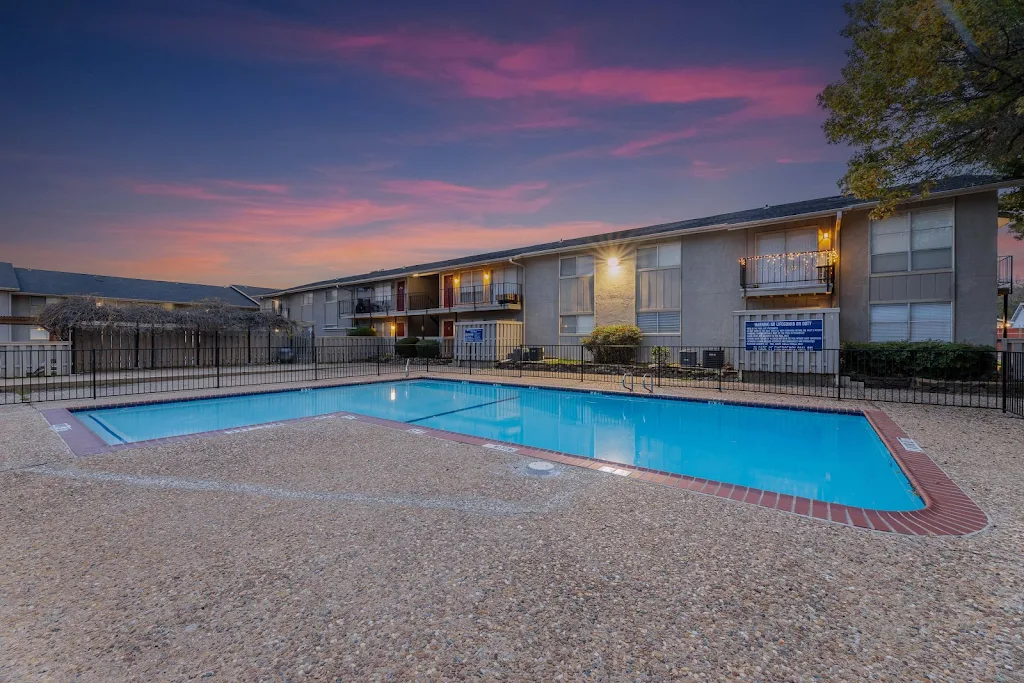 Centerville Crossing Apartments' swimming pool at dusk with surrounding stone patio