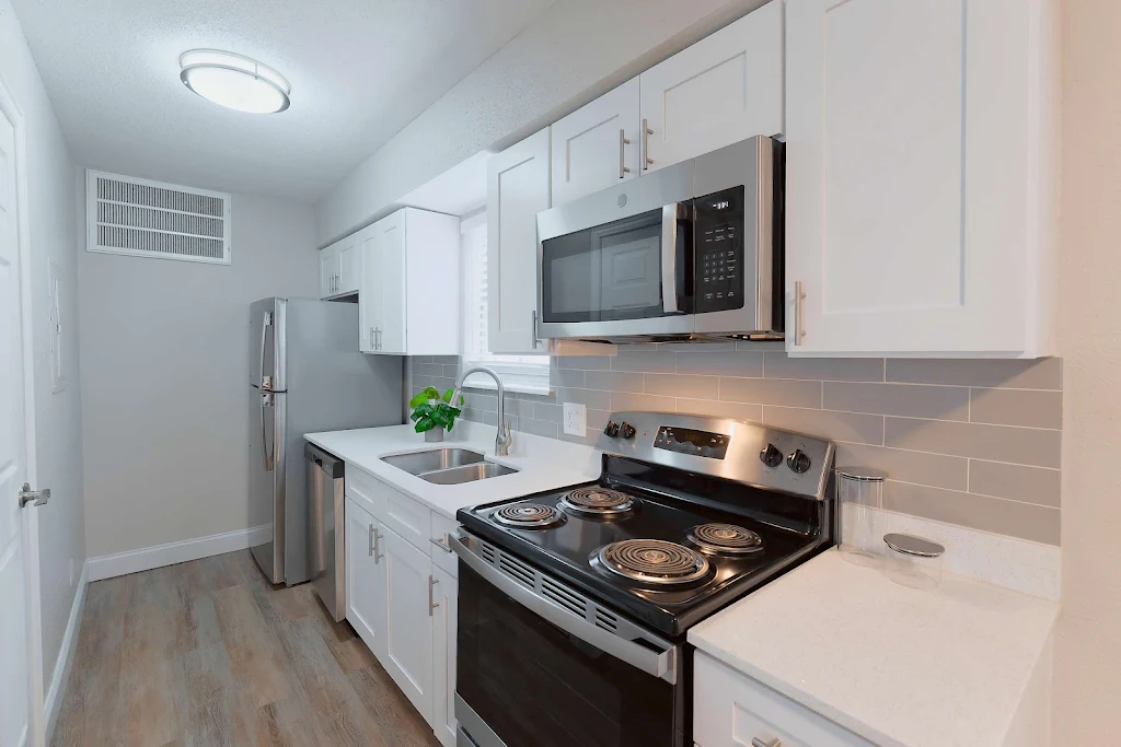 Kitchen with white cabinets and light gray subway tile backsplash