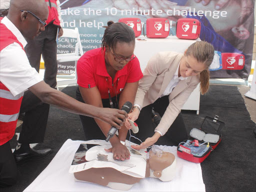 Kenya Red Cross Society medical director Dr Muthoni Ntonjira and Philips EA's Raziye Cavusoglu demonstrate how to use an automated external defibrillator.