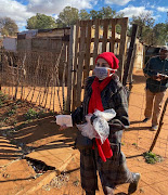 Shaheda Omar director of the Teddy Bear Clinic for abused children handing out food parcels in an informal settlement.