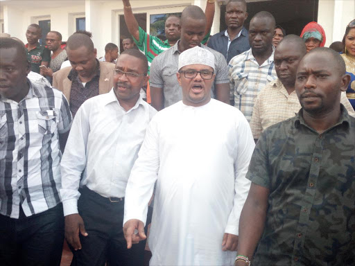 Murang'a Governor Mwangi wa Iria [2nd L] and former Mombasa Senator Hassan Omar [in white kanzu] leave the luncheon at Jubilee Hall in Mombasa on Friday, October 20, 2017. /BRIAN OTIENO